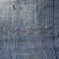 Vintage indigo stripe and Kasuri patterned cotton with a hole.