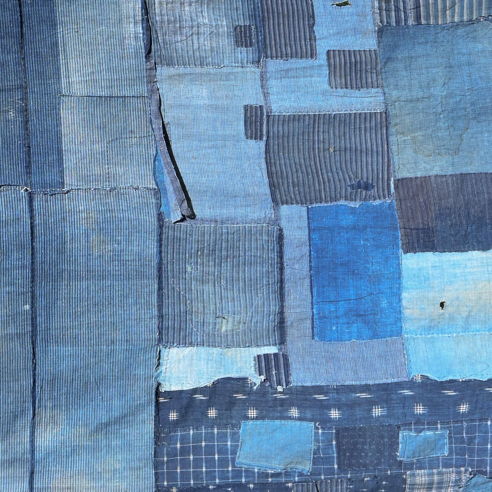 Part of vintage old Japanese Boro indigo cotton futon cover with lots of patches.