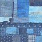 Section of vintage old Japanese Boro indigo cotton futon cover with lots of patches, showcasing Kasuri cotton pieces.