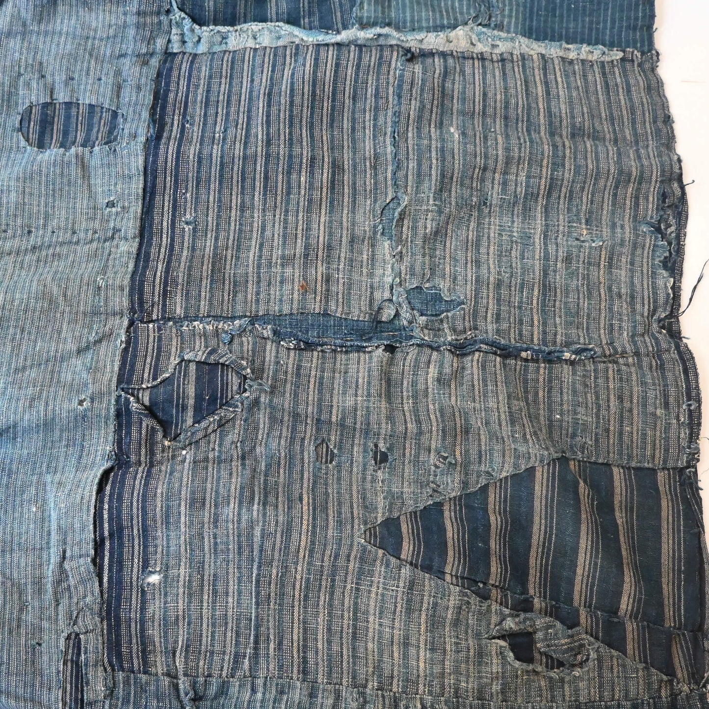 Vintage old indigo strip cotton with hand stitched mends.