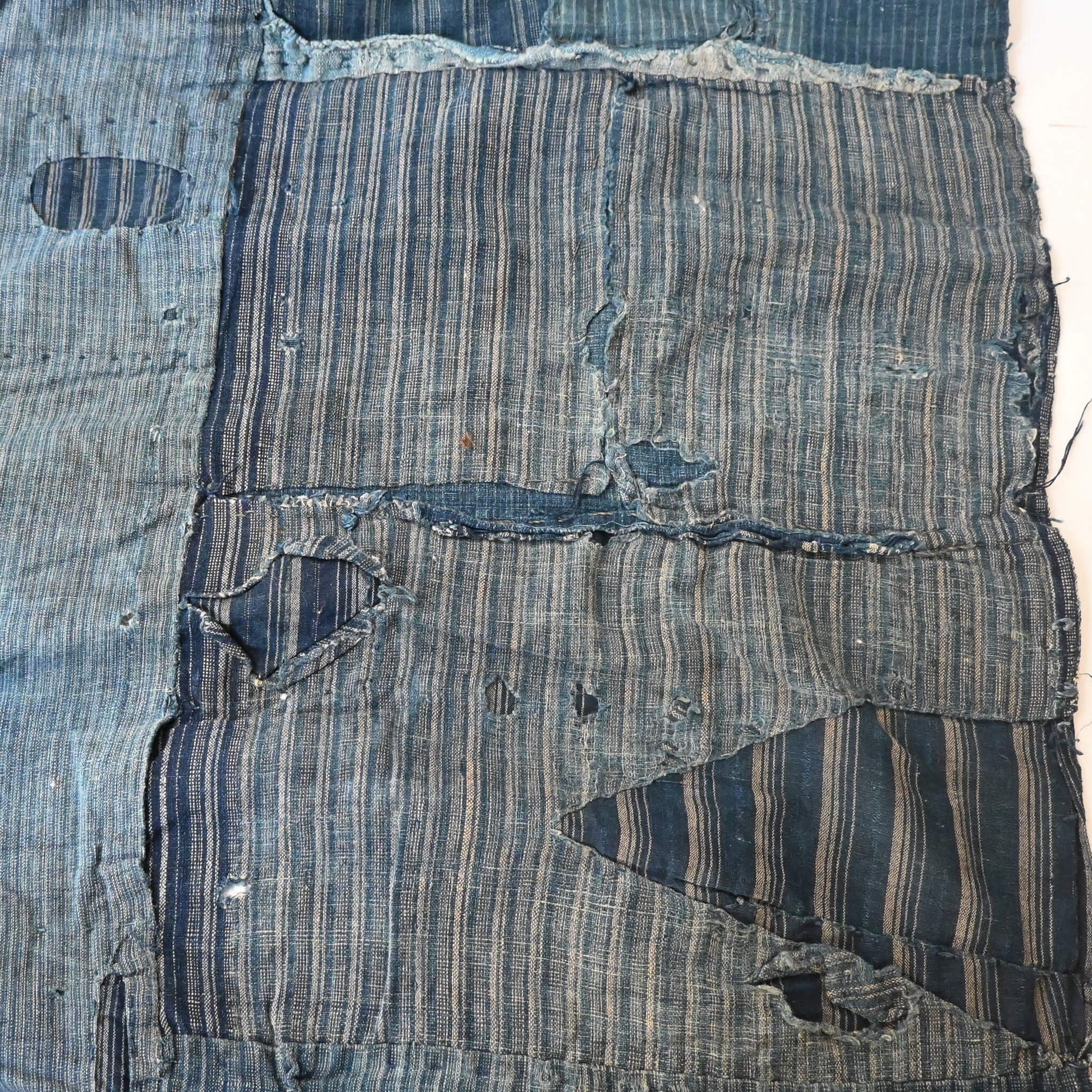 Vintage old indigo strip cotton with hand stitched mends.