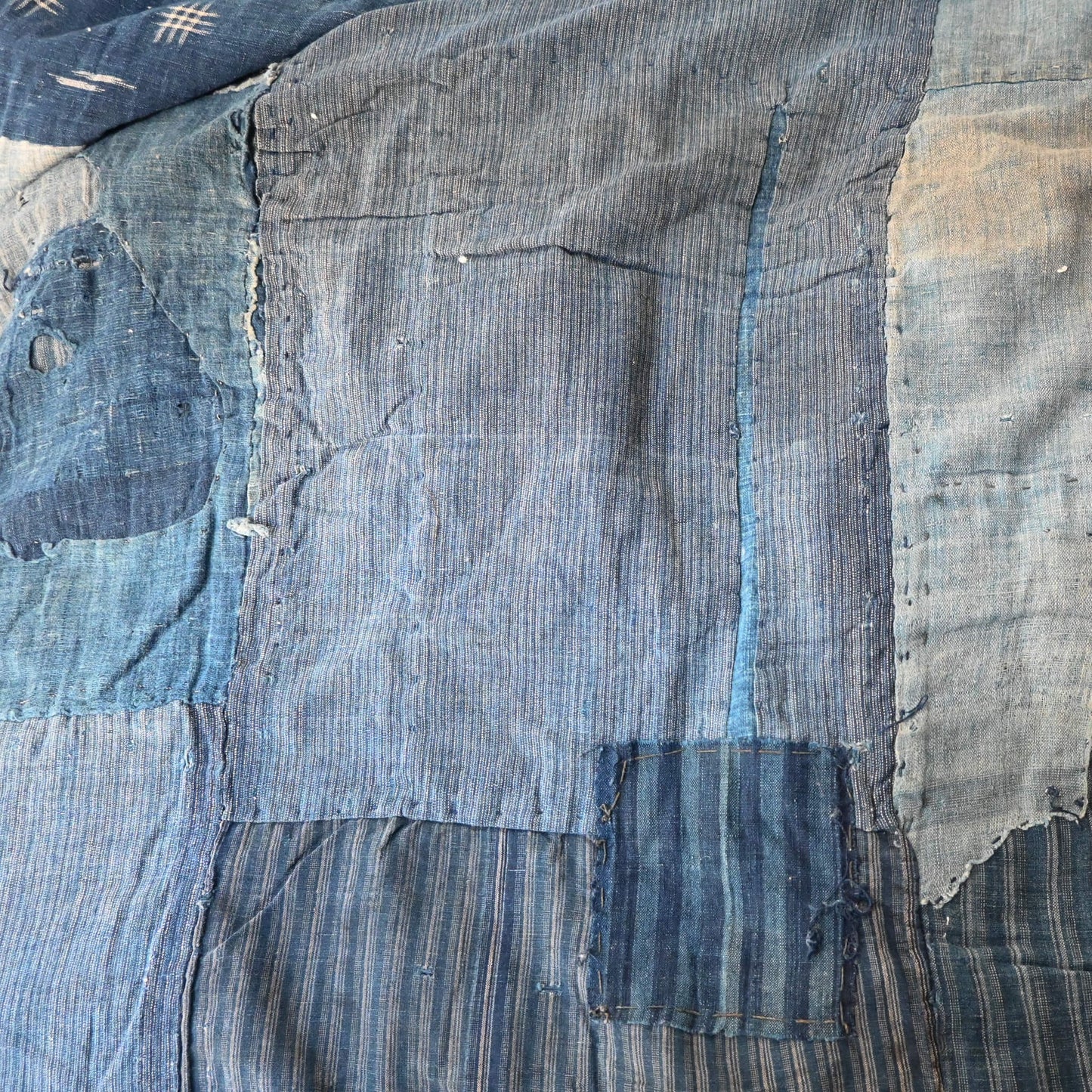 Vintage indigo Boro futon cover, carefully mended by hand stitching.