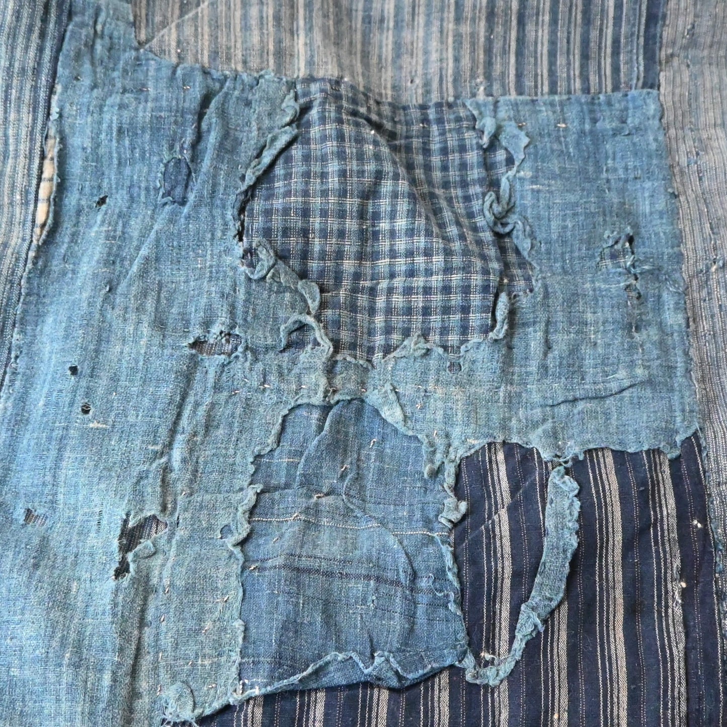 Vintage indigo futon cover, showcasing beautifully worn out part.