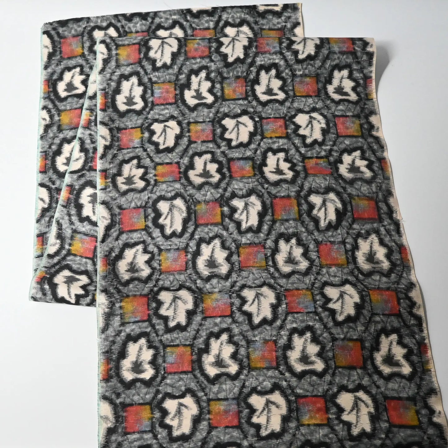 Full view of vintage Japanese Meisen silk kimono fabric piece with a leaf motif in grey and pink from the mid-20th century.