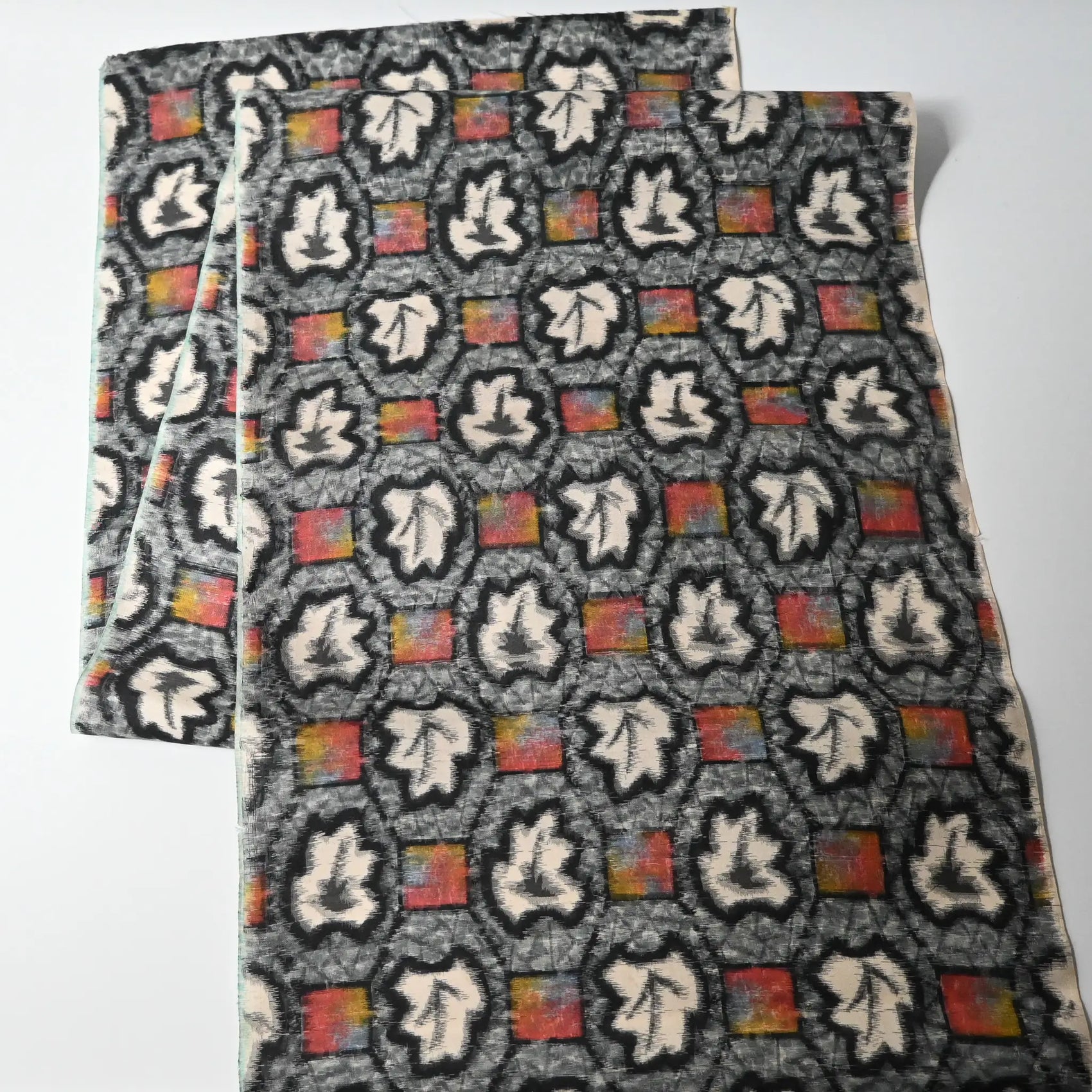 Full view of vintage Japanese Meisen silk kimono fabric piece with a leaf motif in grey and pink from the mid-20th century.