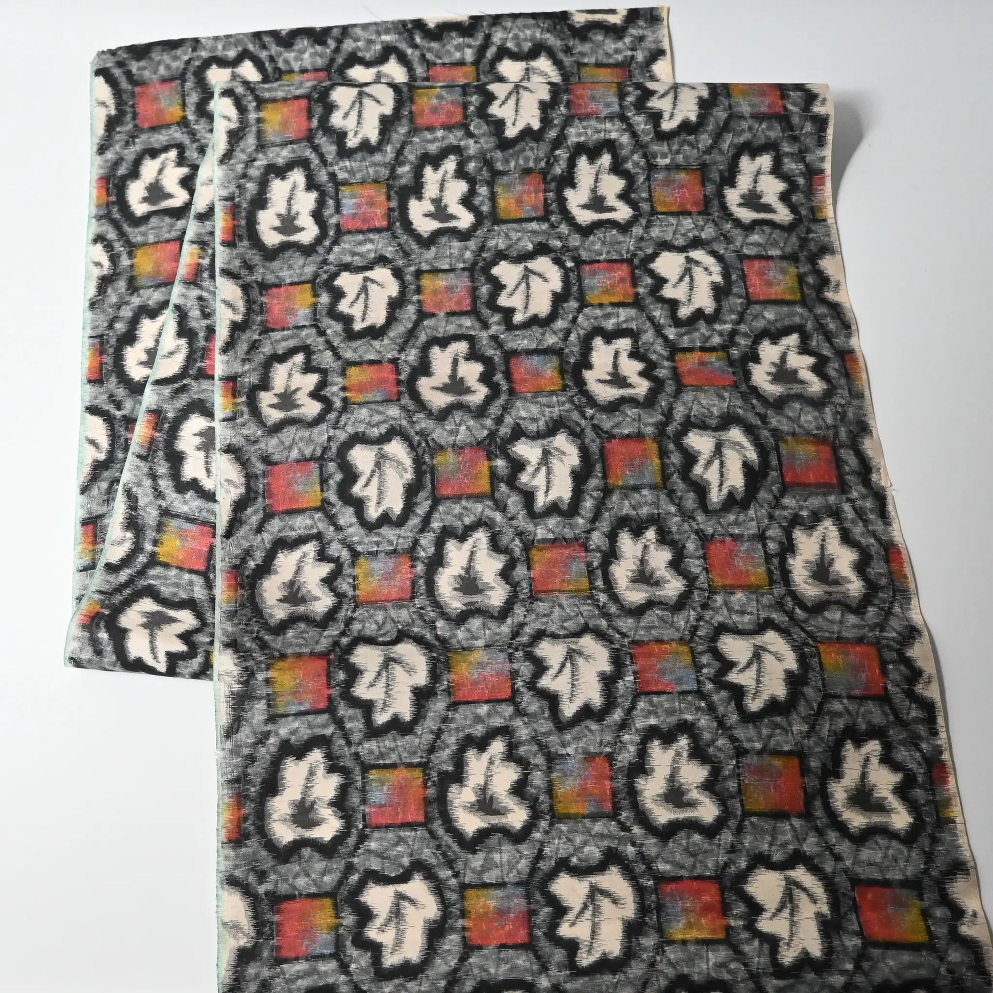 Full view of vintage Japanese Meisen silk kimono fabric piece with a leaf motif in grey and pink from the mid-20th century.