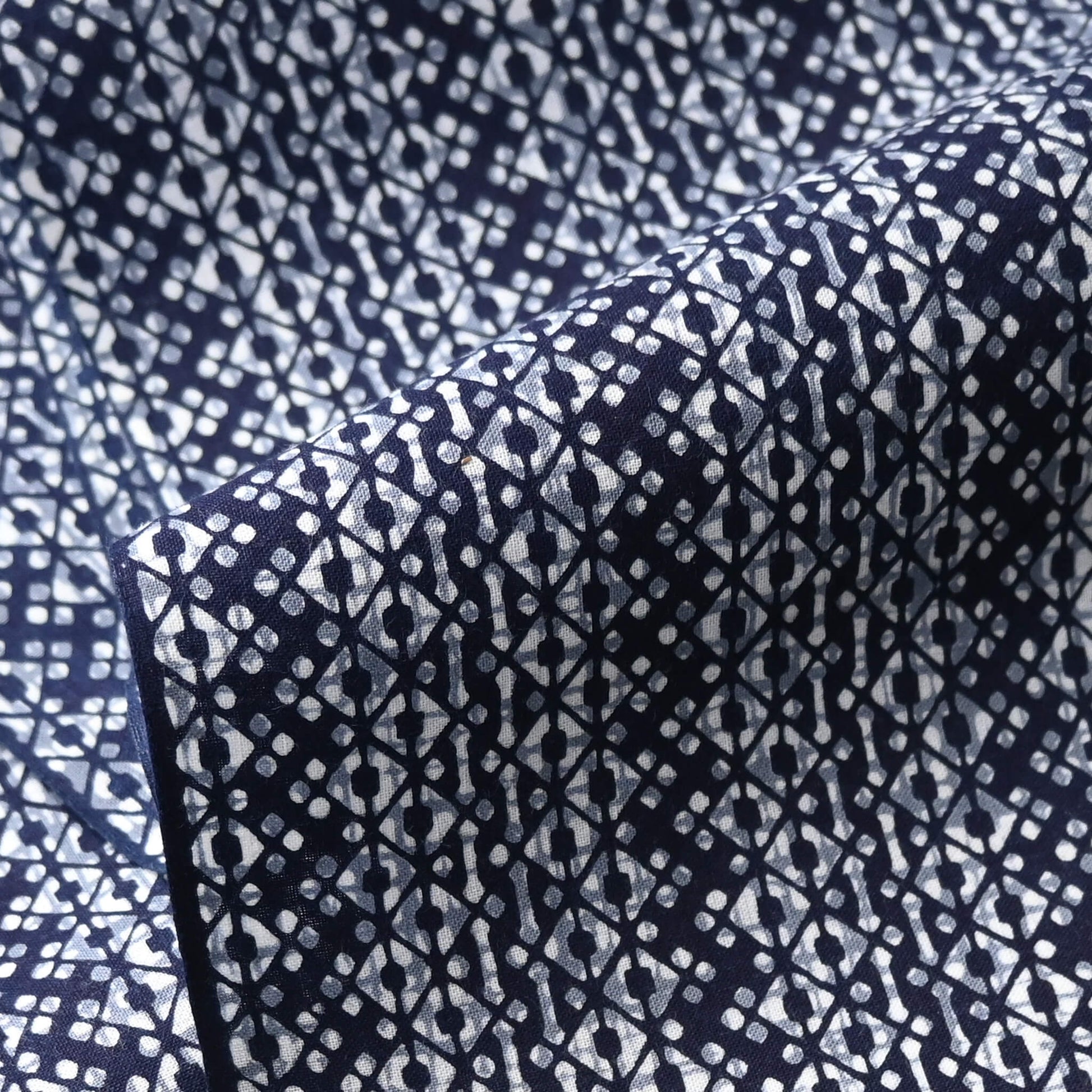 Close-up view of vintage traditional Japanese men's cotton yukata fabric with geometric pattern.