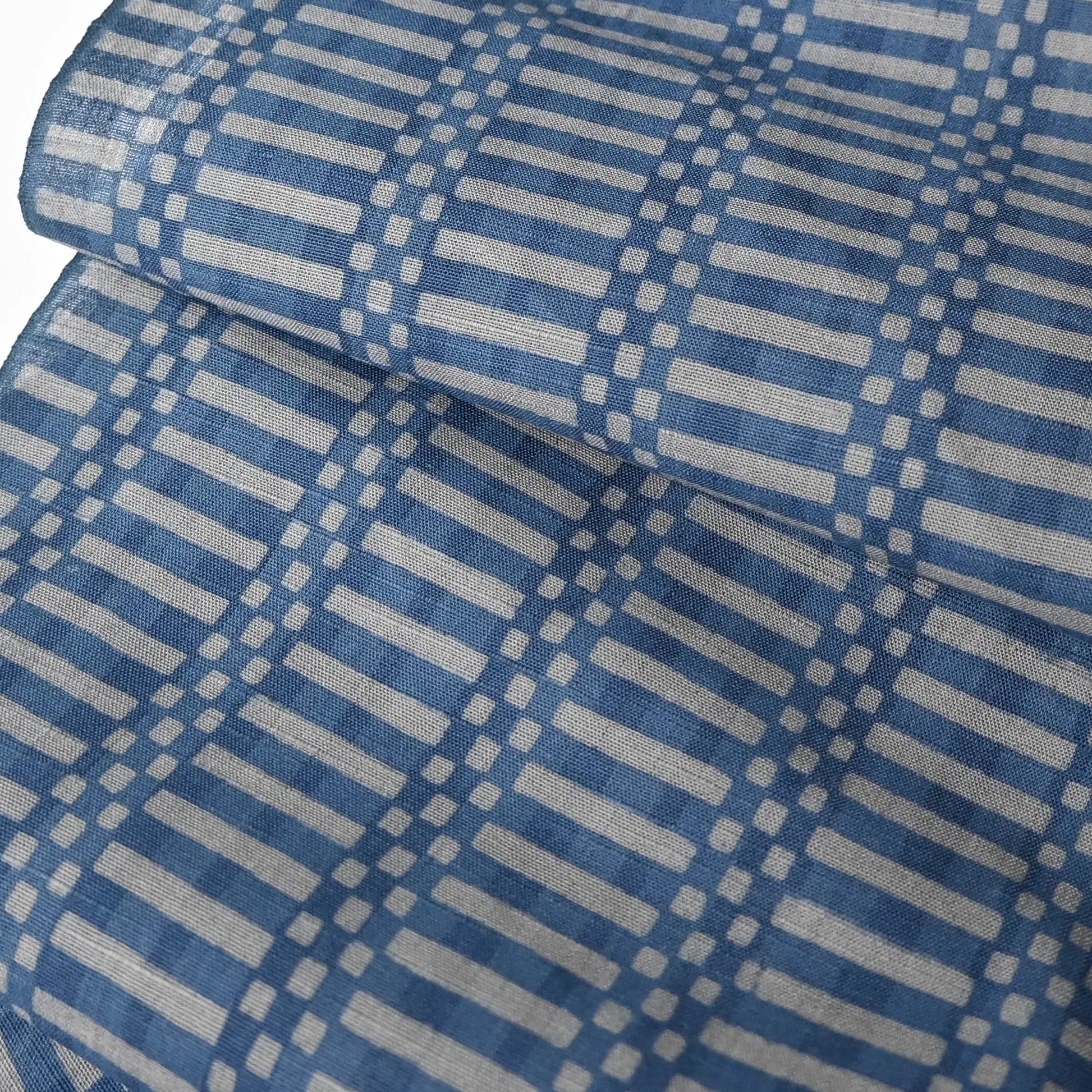 Close-up view of vintage Japanese men's yukata cotton fabric, soft blue and grey geometric check design, sold by the metre.