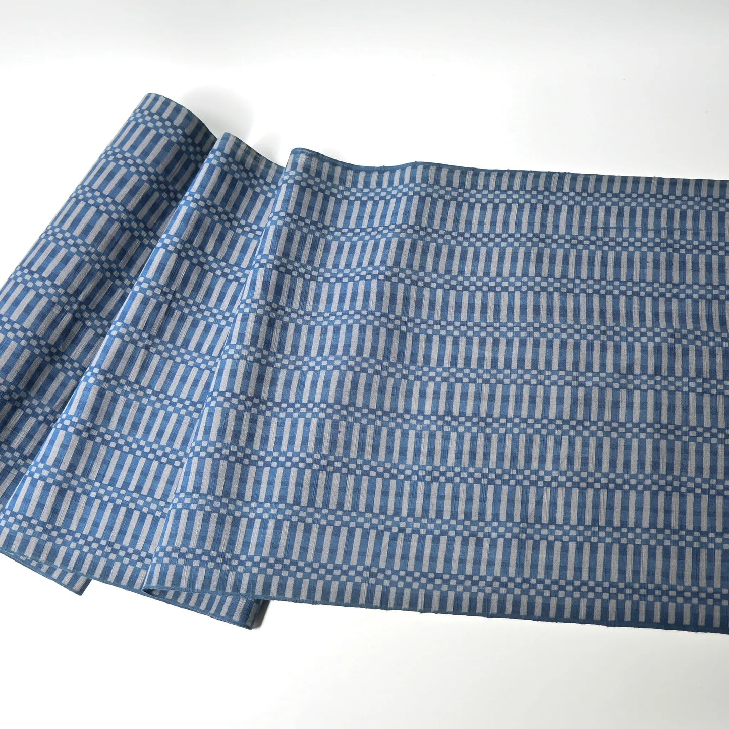 Full view of vintage Japanese men's yukata cotton fabric, soft blue and grey geometric check design, sold by the metre.