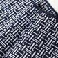 Close-up view of vintage Japanese men's yukata cotton fabric with geometric pattern, sold by the metre.