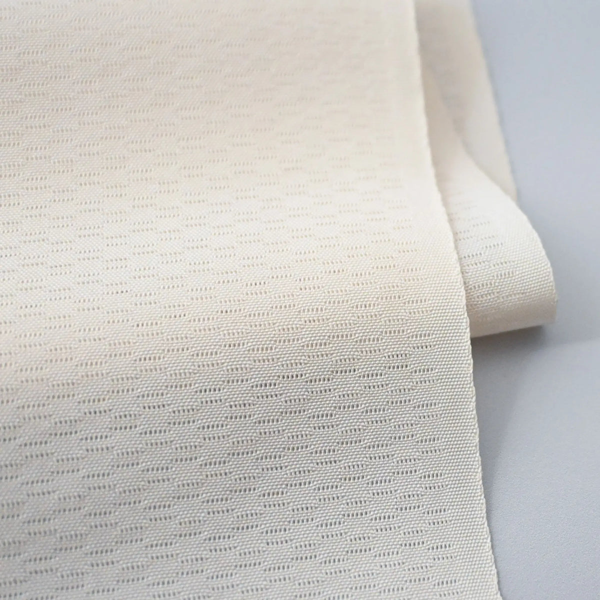 Detailed view of vintage Japanese plain Ro silk jacquard kimono fabric.