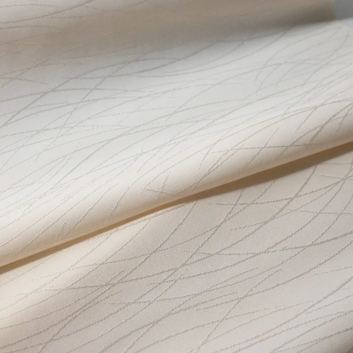 Detailed view of vintage Japanese plain silk jacquard kimono roll with grass motif.