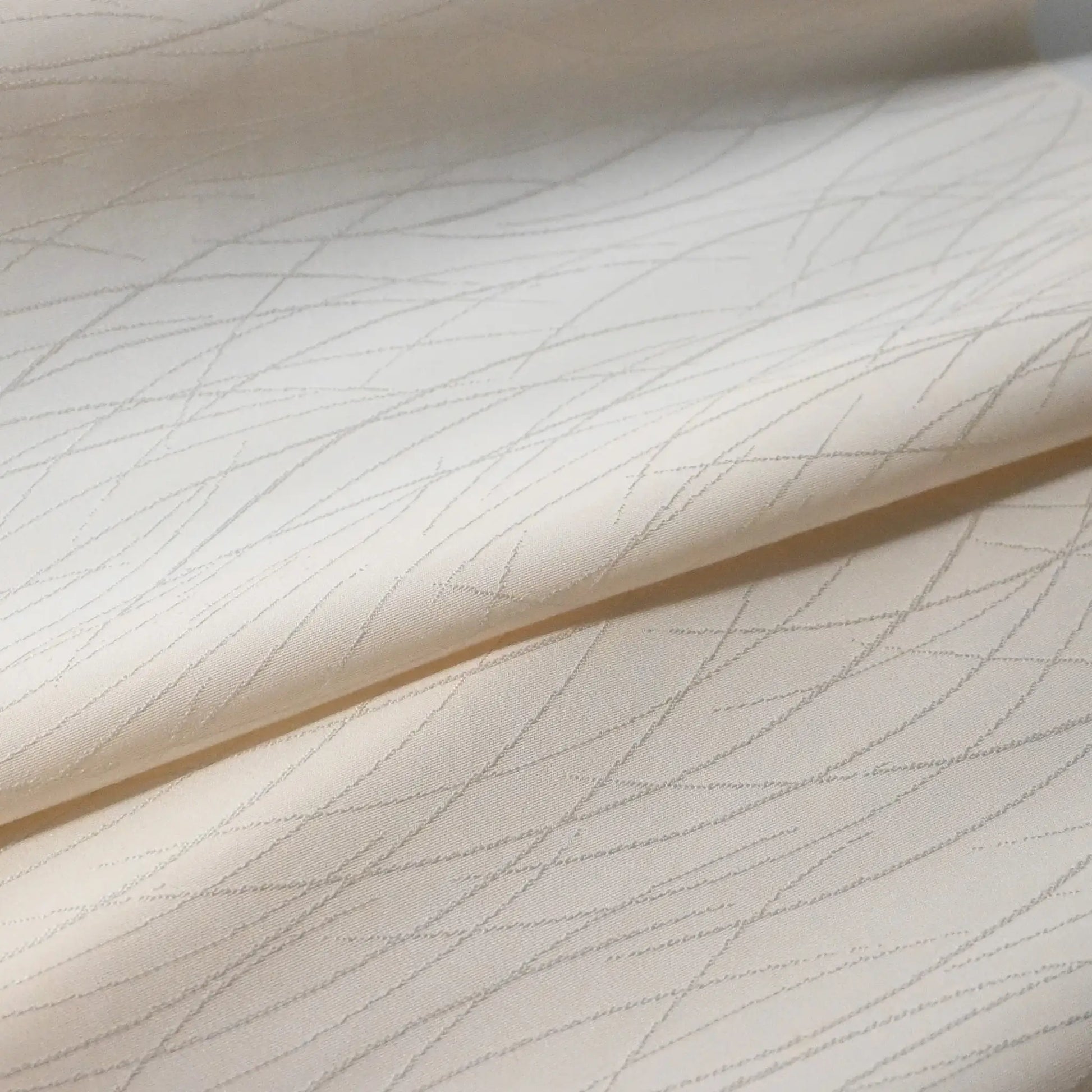 Detailed view of vintage Japanese plain silk jacquard kimono roll with grass motif.