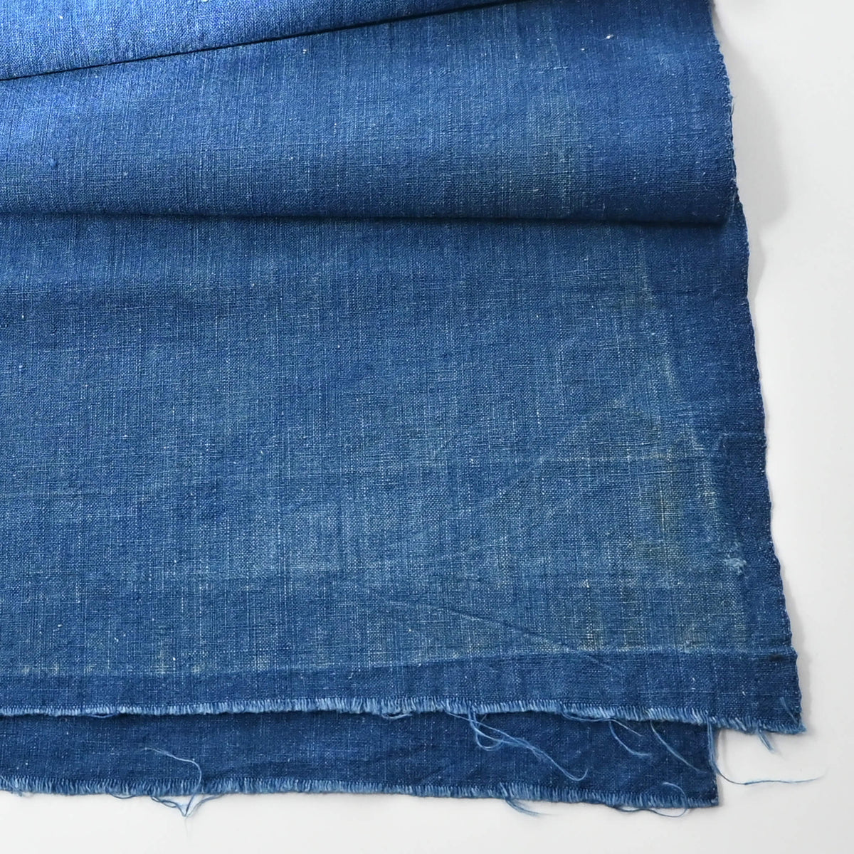 Detailed view of vintage Japanese plain indigo cotton from old kimono with some mends.