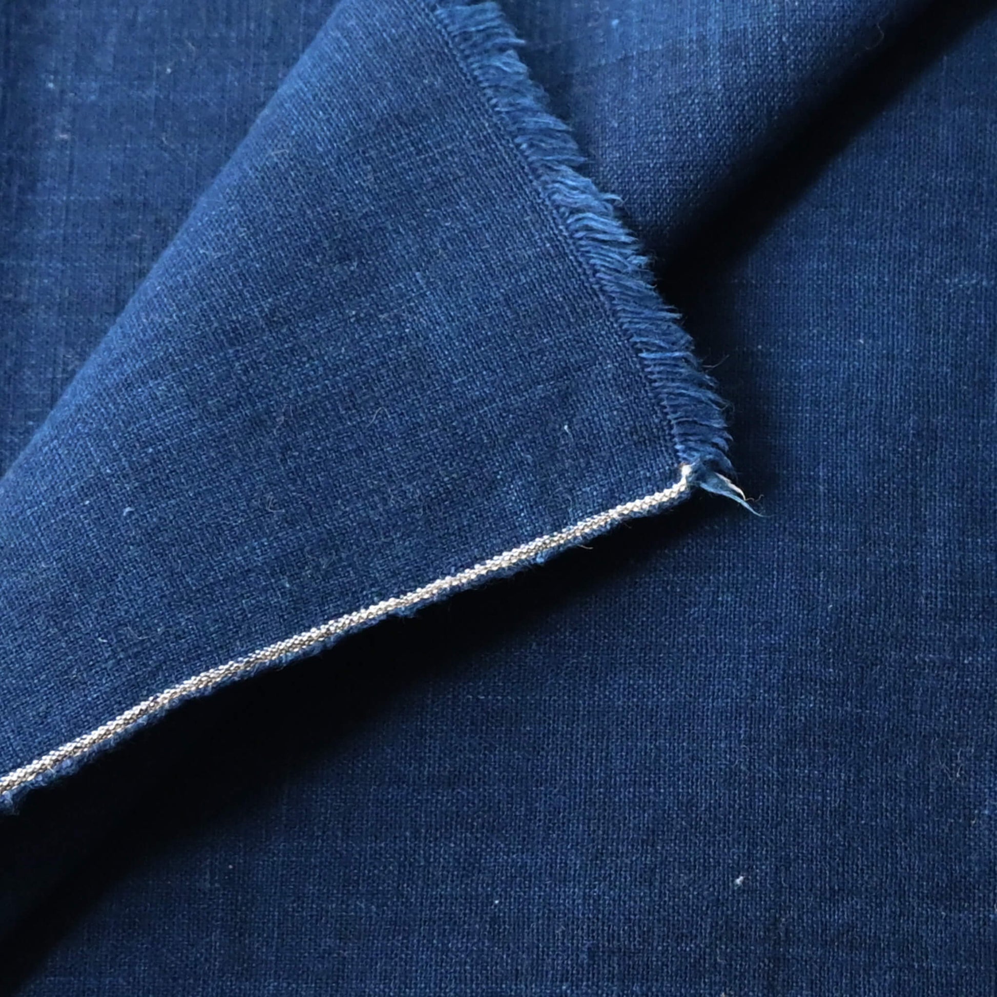 Close-up view of vintage Japanese plain light indigo cotton piece with a soft handle.