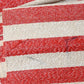 Stained part of vintage Japanese Shifu paper yarn red and white stripe obi from the mid-20th century.