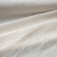 Detailed view of vintage Japanese silk jacquard kimono fabric with running water motif.