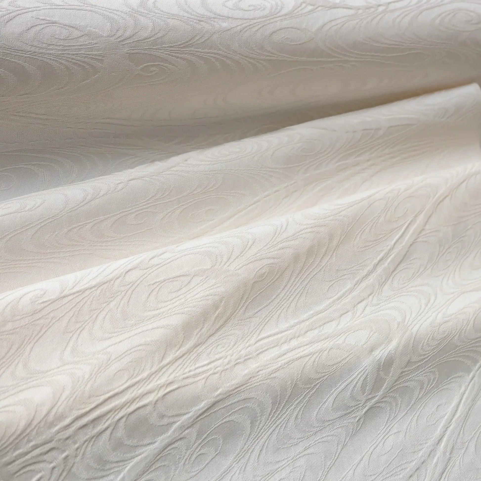 Detailed view of vintage Japanese silk jacquard kimono fabric with running water motif.