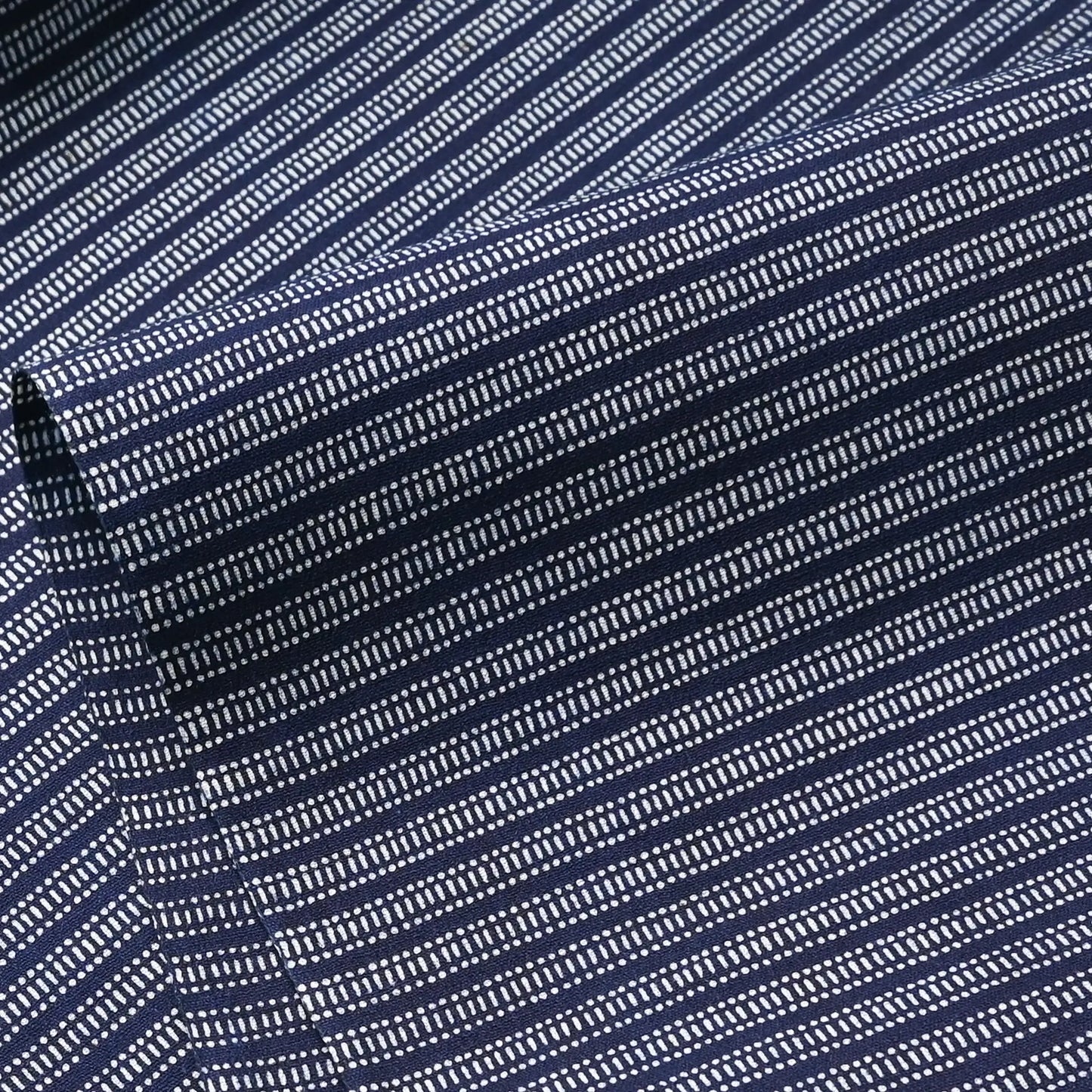 Close-up view of vintage Japanese geometric yukata cotton fabric sold by the metre.