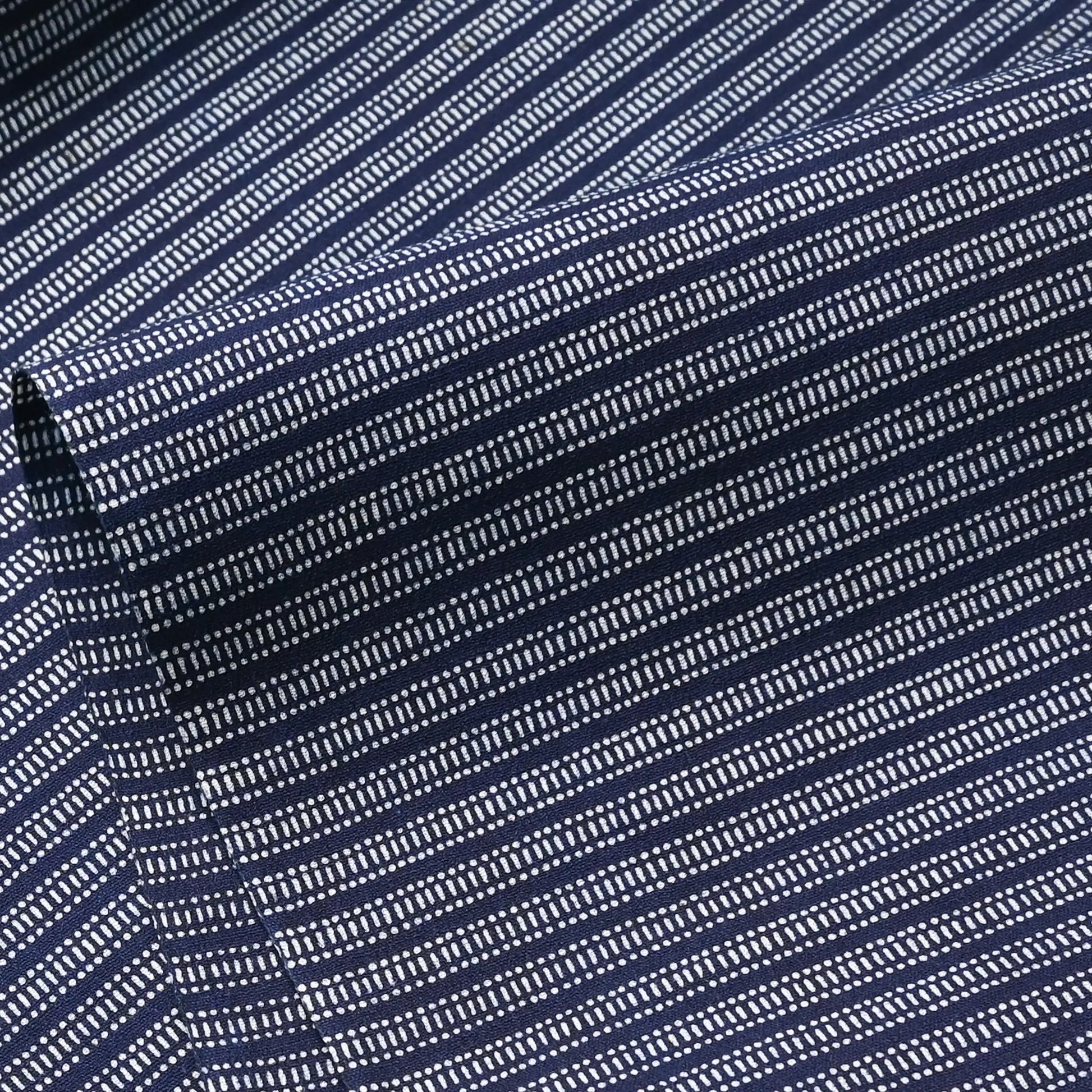 Close-up view of vintage Japanese geometric yukata cotton fabric sold by the metre.