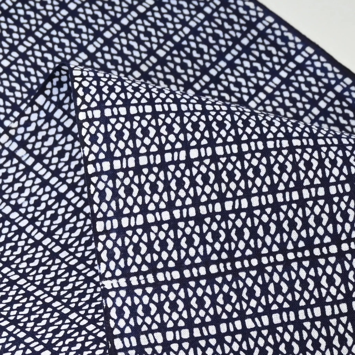 Close-up view of vintage Japanese geometric yukata cotton fabric sold by the metre.