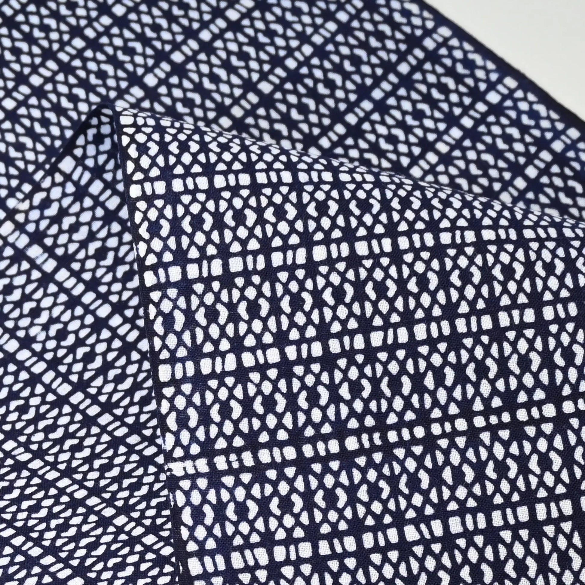 Close-up view of vintage Japanese geometric yukata cotton fabric sold by the metre.