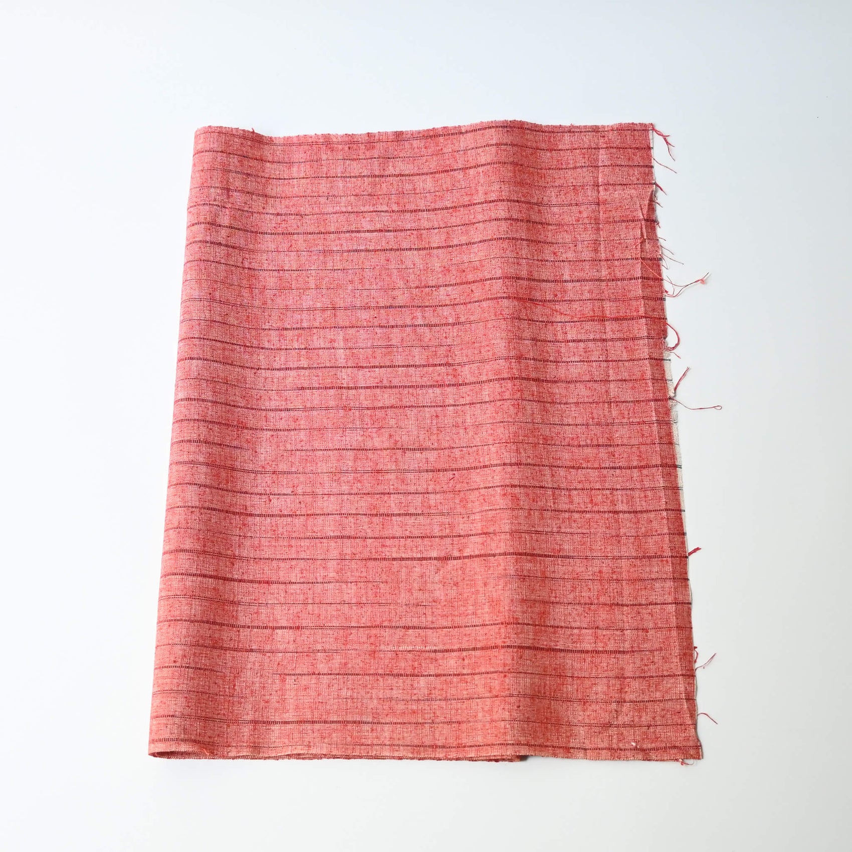 Vintage strawberry red tusmugi silk kimono fabric with stripe pattern.