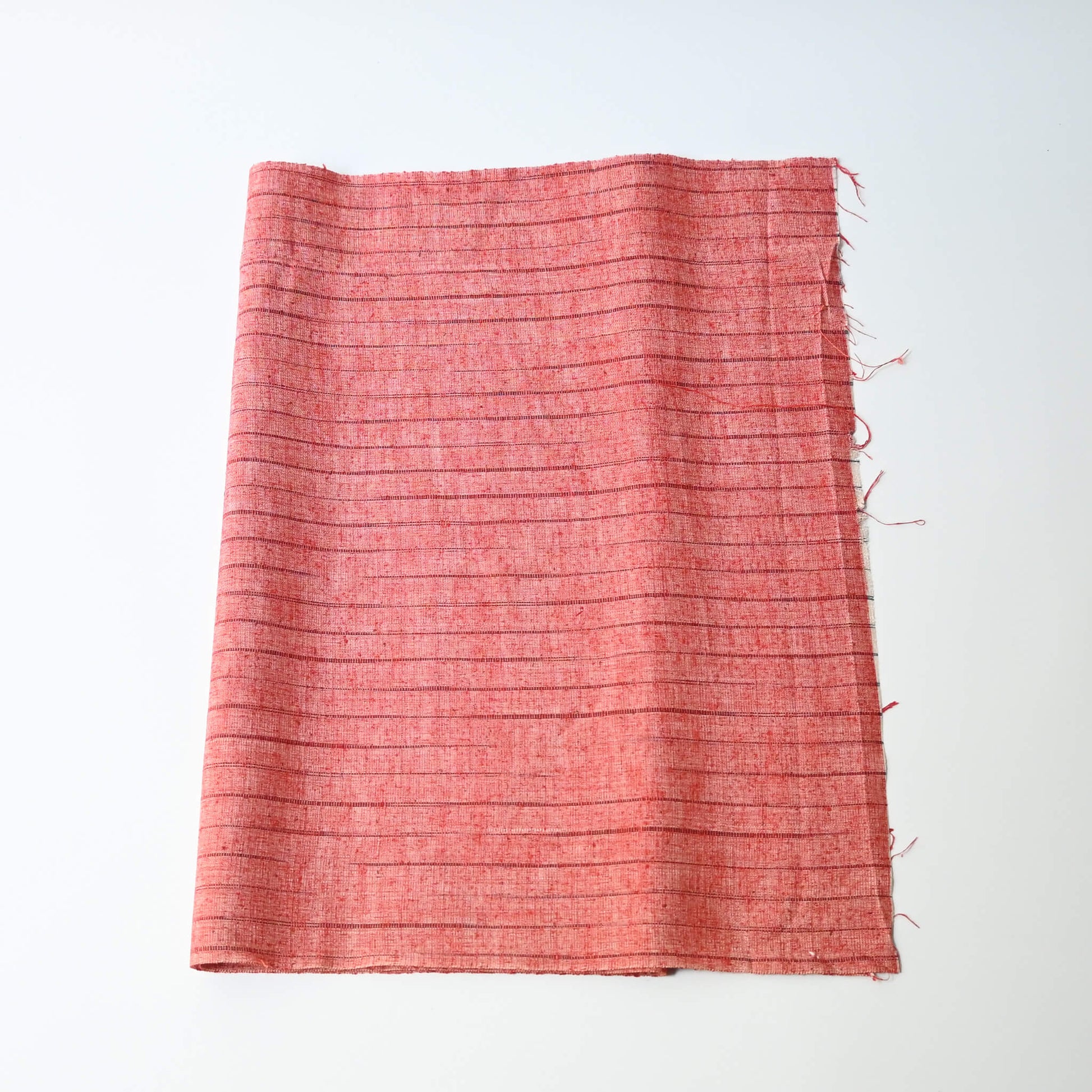 Vintage strawberry red tusmugi silk kimono fabric with stripe pattern.