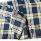Vintage Japanese indigo and soft yellow check cotton futon cover panel with mended patches.