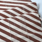 Detailed view of vintage Japanese white and brown diagonal stripe cotton.
