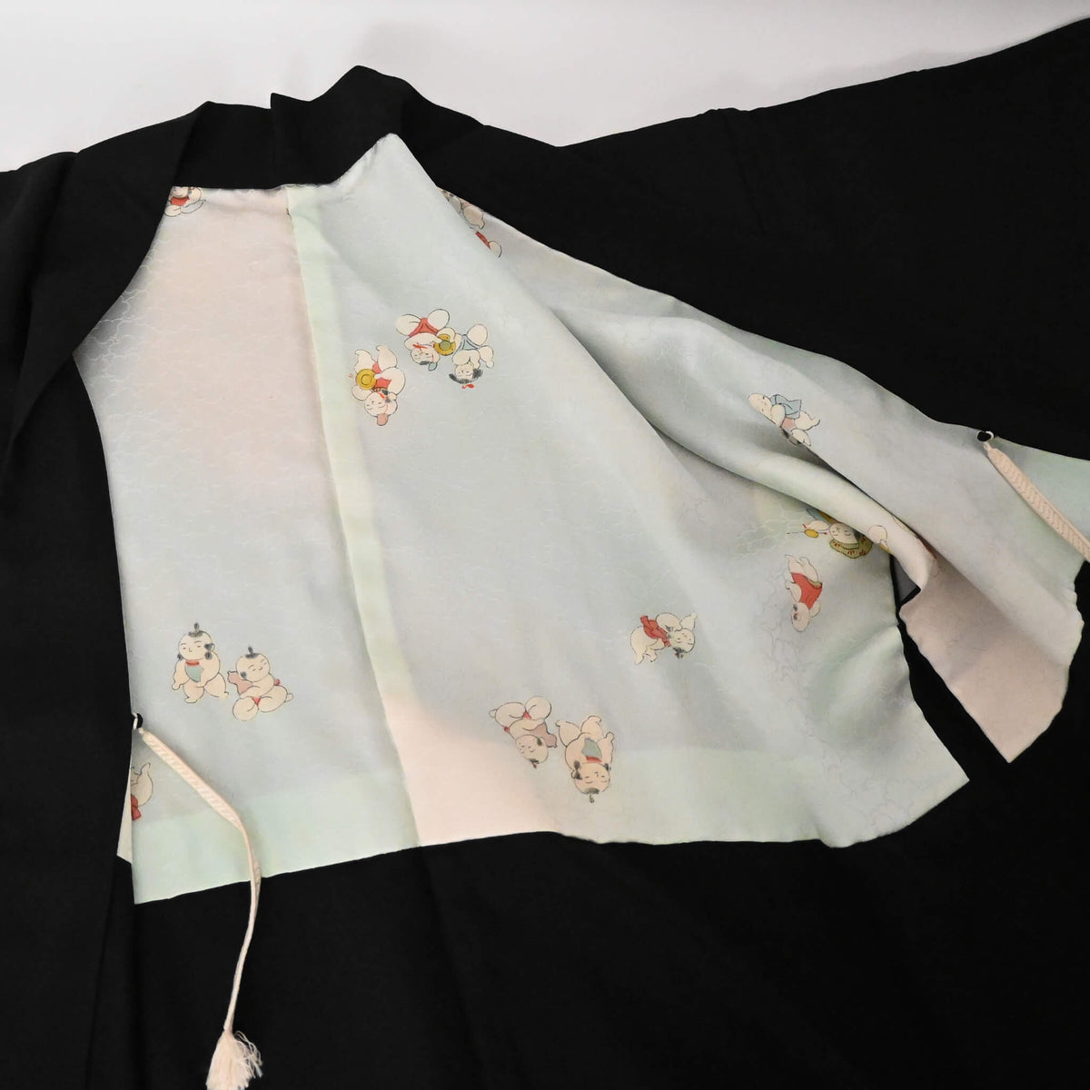 Vintage Japanese women's black silk crepe haori with light blue silk lining.