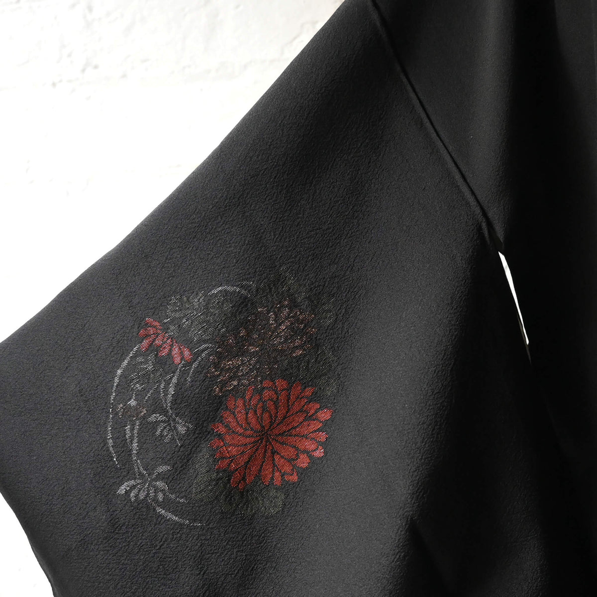 Vintage Japanese black silk crepe haori with woven floral motifs.