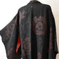 The back bodice of vintage women's black silk crepe haori with woven peony pattern created with lacquer-coated threads.