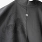 Close-up view of vintage Japanese women's silk haori with black-on-black jacquard chrysanthemum pattern.