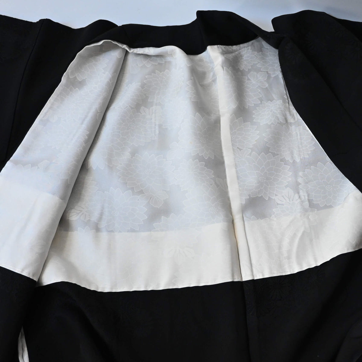 Vintage Japanese women's silk haori with black-on-black jacquard chrysanthemum pattern.