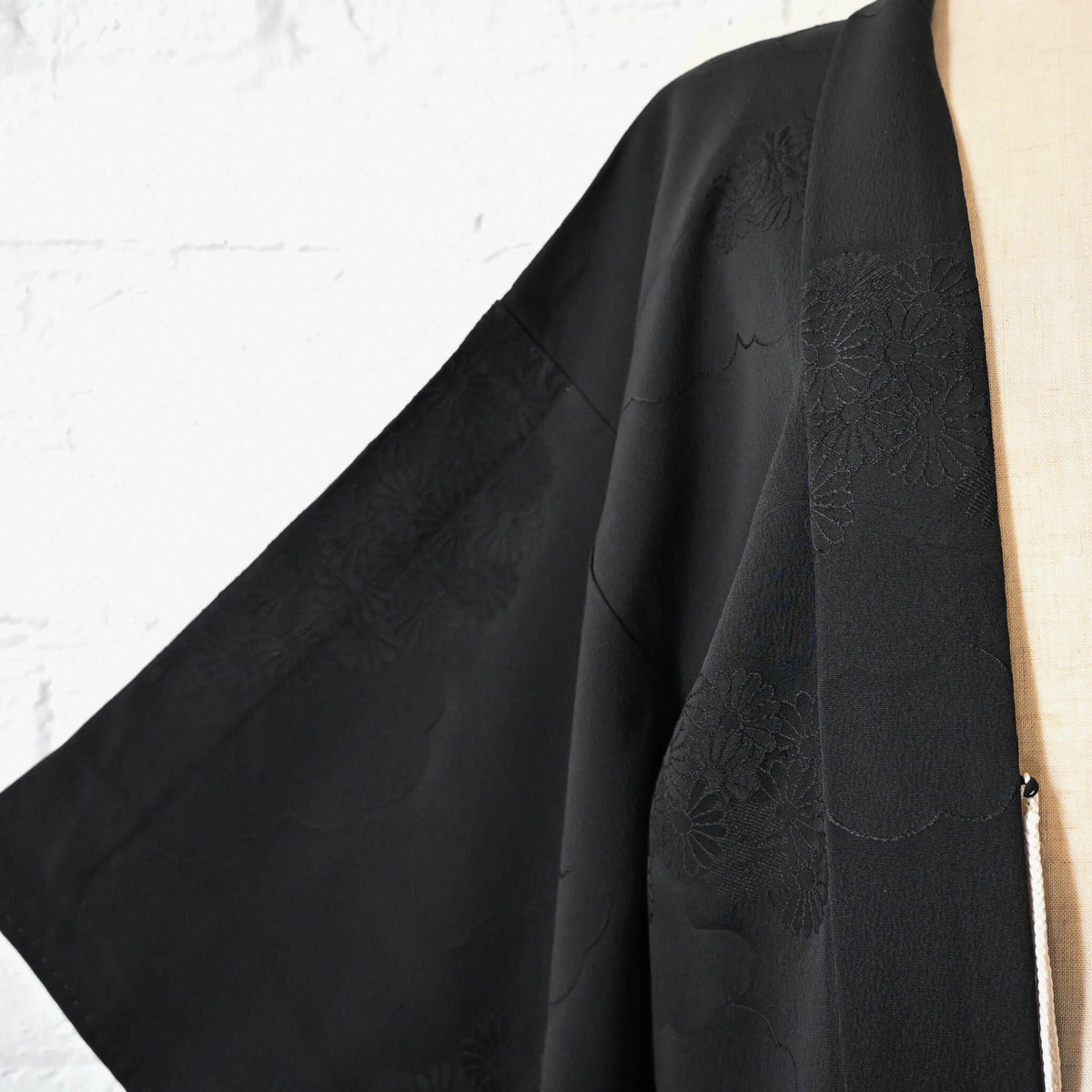 Vintage Japanese women's silk haori with black-on-black jacquard chrysanthemum pattern.