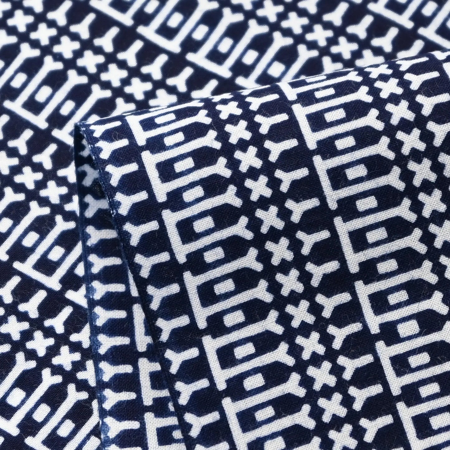 Close-up view of vintage Japanese geometric yukata cotton fabric sold by the metre.
