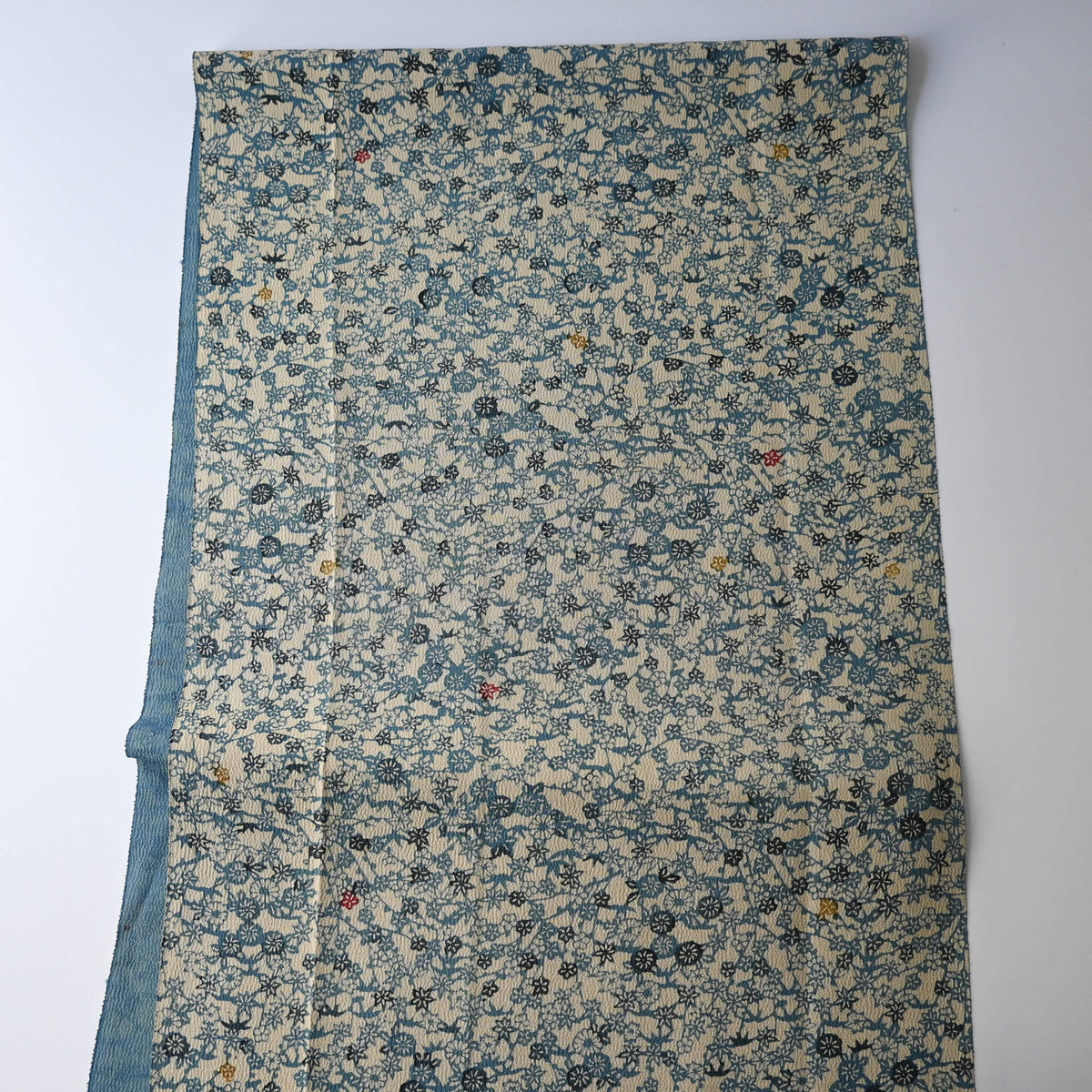 Vintage katazome stencil dyed silk crepe kimono fabric with small floral pattern, including plum blossoms and chrysanthemums.