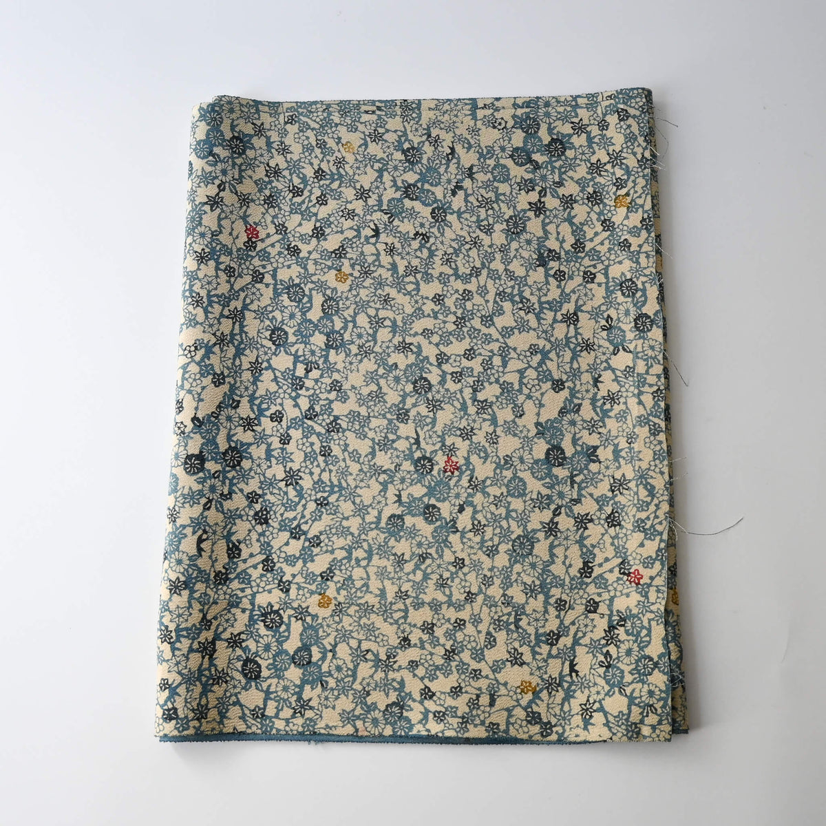 Vintage katazome stencil dyed silk crepe kimono fabric with small floral pattern, including plum blossoms and chrysanthemums.