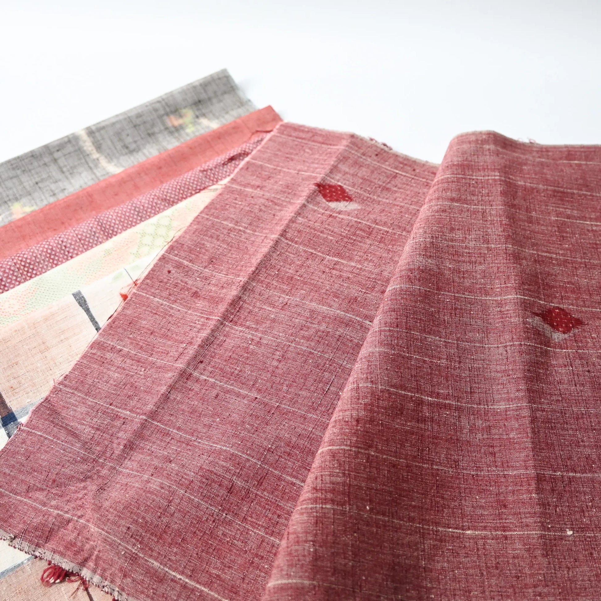 Set of six vintage kimono fabric pieces in soft red tone, perfect for patchwork and craft project.