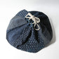 A rare vintage Japanese komebukuro, a traditional drawstring cotton rice bag hand pieced from a variety of indigo cottons.