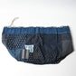 Inside of a rare vintage Japanese komebukuro, a traditional drawstring cotton rice bag hand pieced from a variety of indigo cottons with mended patches.