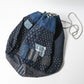Inside of a rare vintage Japanese komebukuro, a traditional drawstring cotton rice bag hand pieced from a variety of indigo cottons with mended patches.