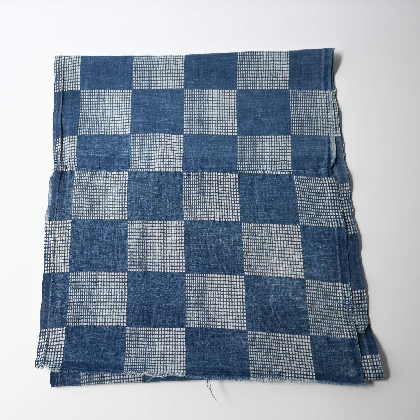 Full view of vintage lightweight soft indigo cotton piece from an old kimono with a large chequered design.
