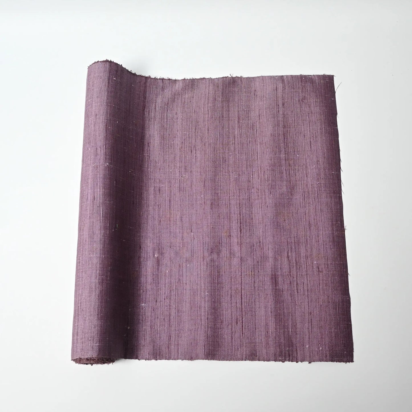 Vintage lilac tsumugi silk kimono fabric roll with textured slubs.