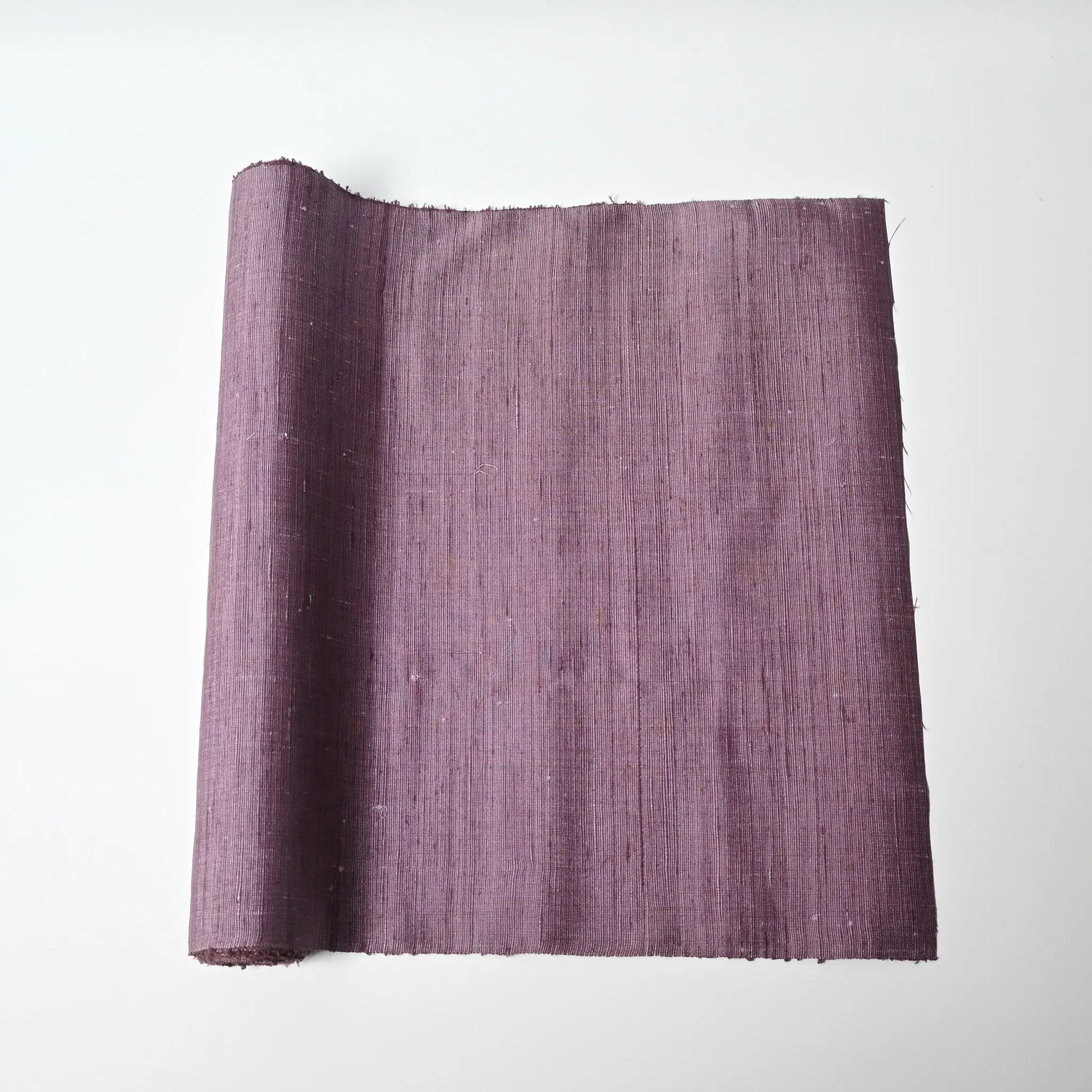 Vintage lilac tsumugi silk kimono fabric roll with textured slubs.