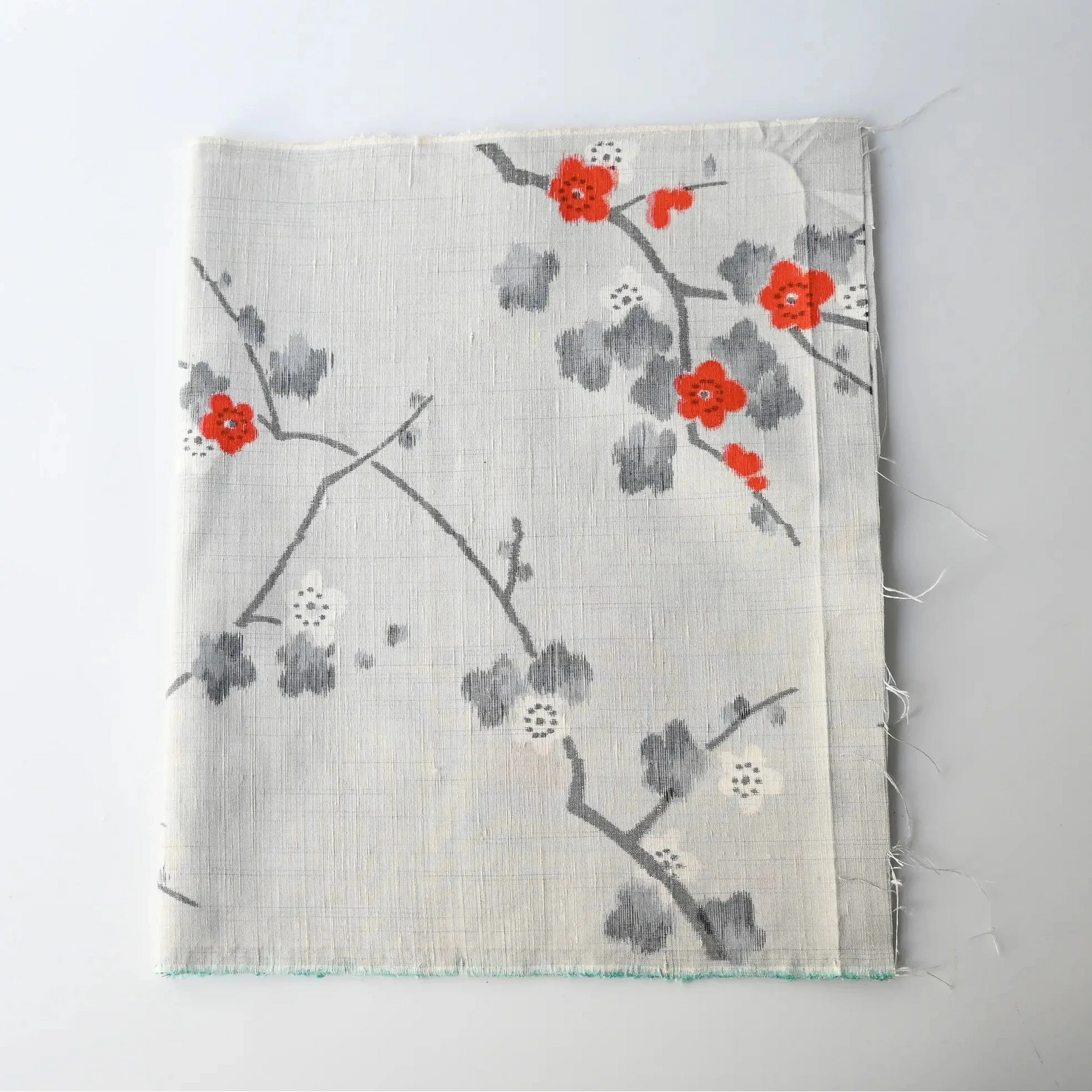 Vintage Japanese tsumugi silk kimono fabric piece in light grey with charming plum blossom design.