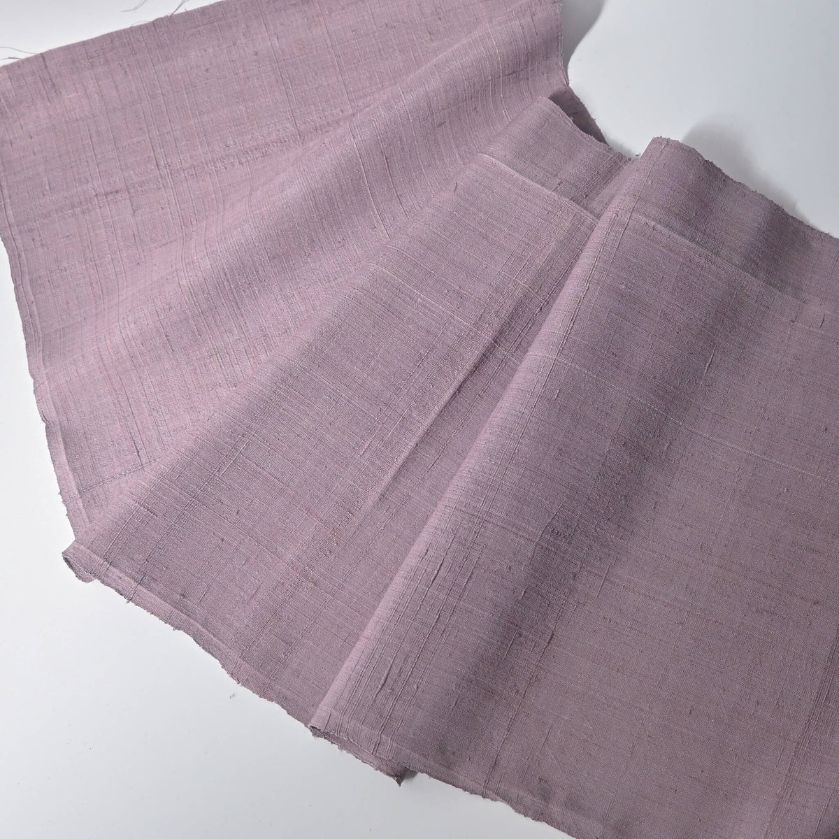 Full view of vintage Japanese slub textured tsumugi silk kimono fabric piece in dusty mauve tone.