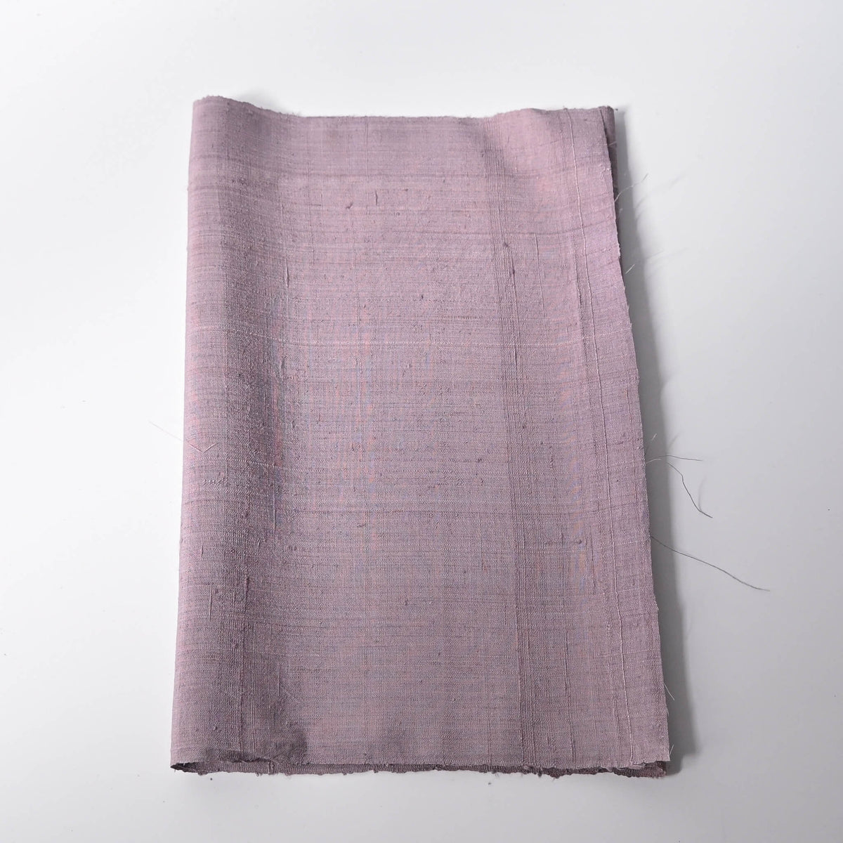 Vintage Japanese slub textured tsumugi silk kimono fabric piece in dusty mauve tone.