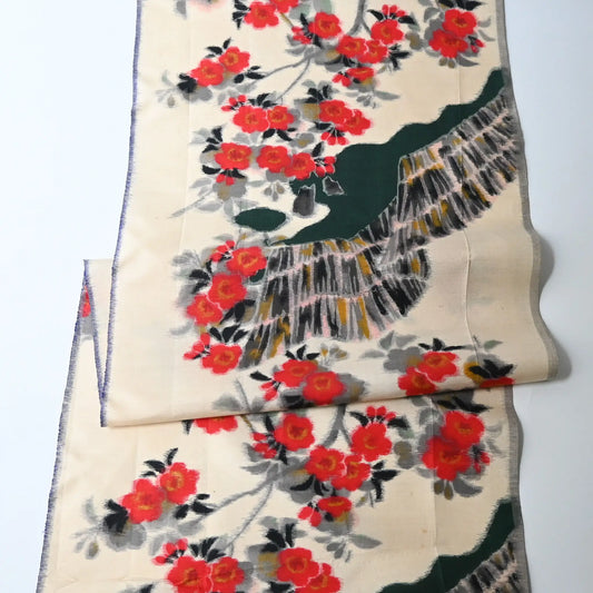 Vintage women's meisen silk kimono fabric piece with red plum blossom motif.